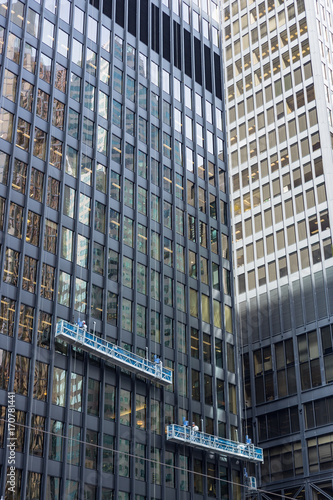 two window cleaning crews working in heights at office tower downtown Toronto