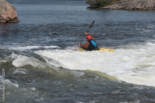 Kayaker running short rapids
