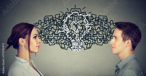 Tableau sur toile Man and woman looking at each other exchanging their thoughts coming up together