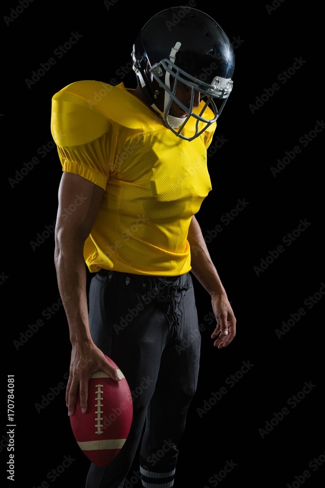 Football Player Holding Football With Both Hands Stock Photo