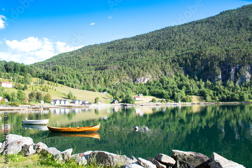 Wooden rowing boat and fjord landscape