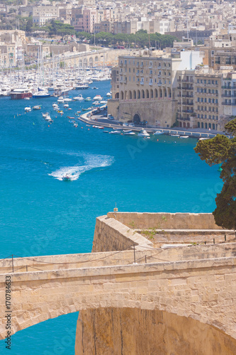 the old bridge leading to city gate in valletta, malta