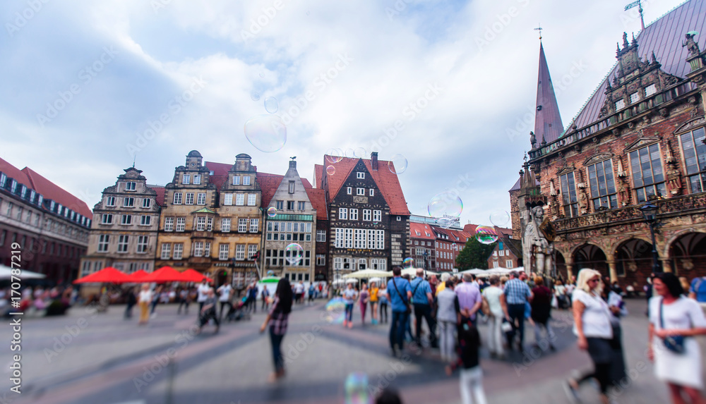 View of Bremen market square with Town Hall, Roland statue and crowd of people, historical center, Germany