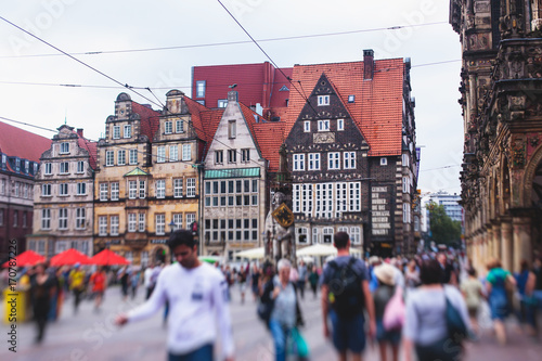 Photography View of Bremen market square with Town Hall, Roland statue and crowd of people,