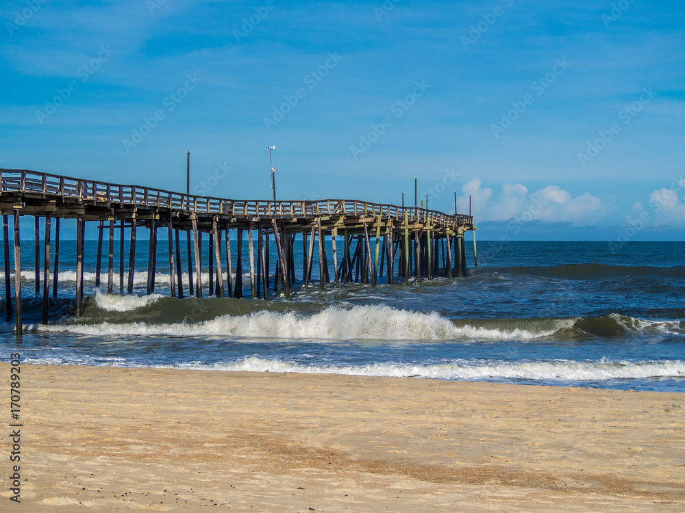 Fishing pier at the sandy beach Fishing pier at the sandy beach