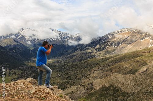 Landscape photographer in mountains