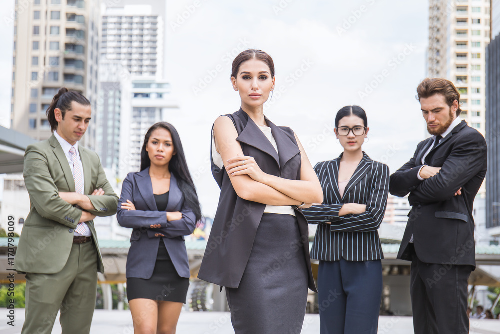 Plakat Business manager standing in office leading her team, woman on top