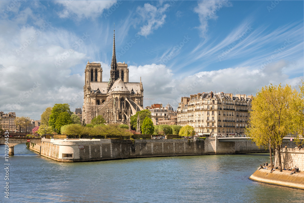 Paris, France - April 18, 2015: View from East across river Seine to Notre Dame de Paris cathedral.