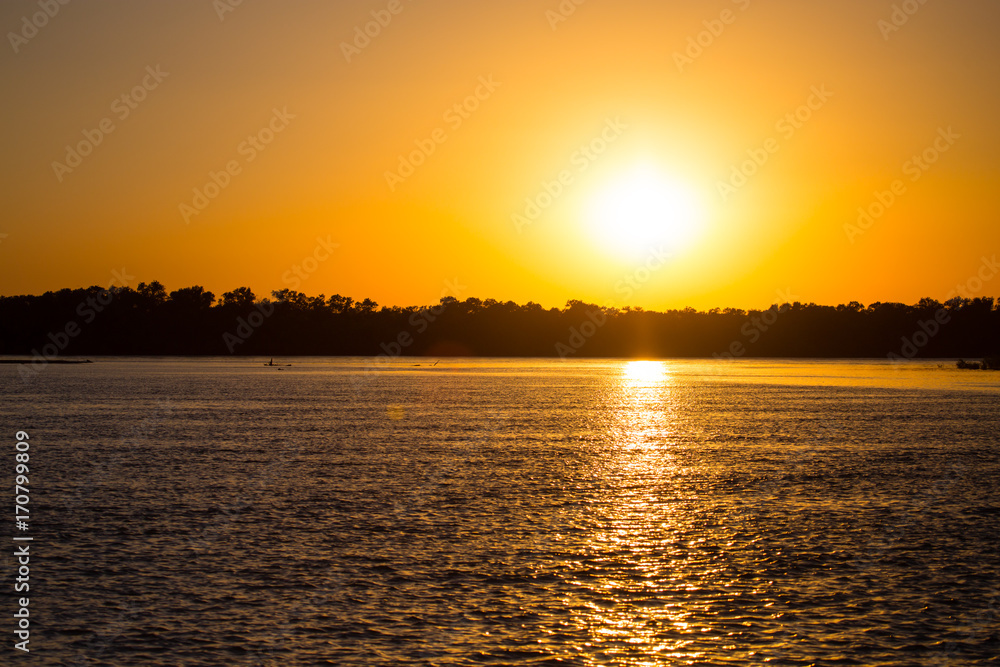 Naklejka premium golden sunset on a river in the nature