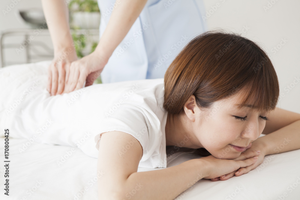 A woman receiving a waist massage