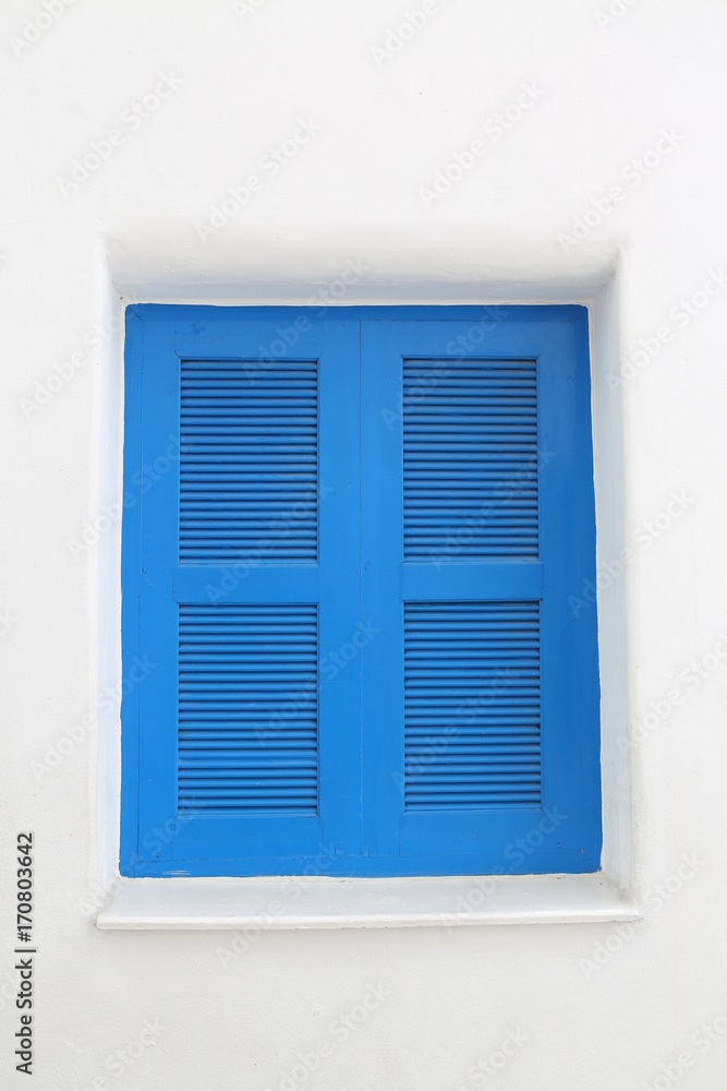 Fototapeta premium Blue wooden window on white cement wall.