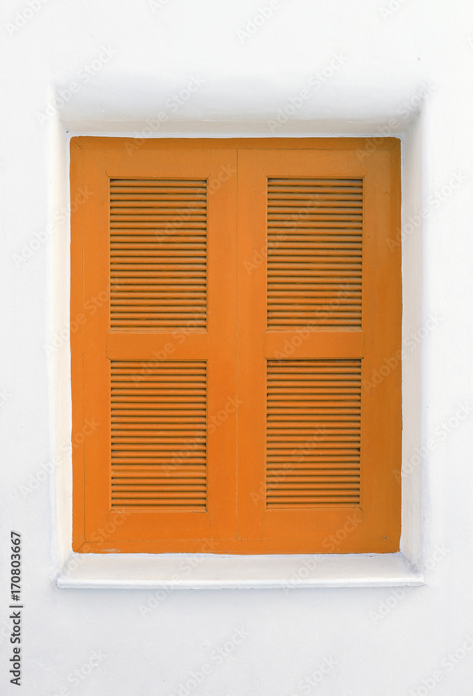 Orange wooden window on white cement wall.