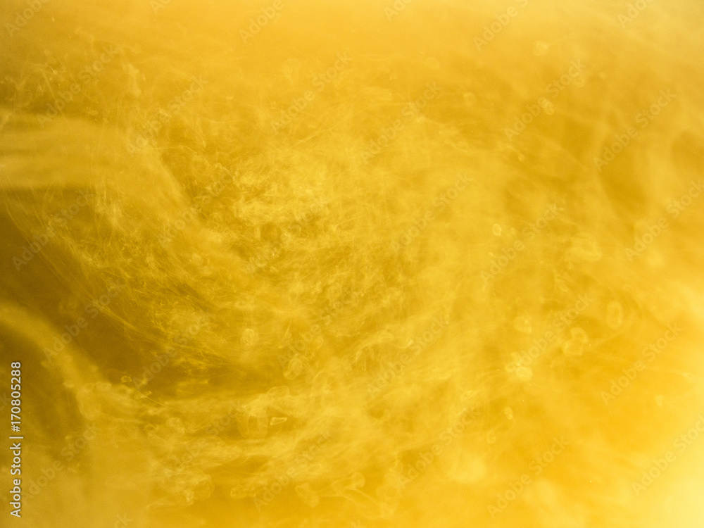 Abstract colored background. Yellow smoke, ink in water, the patterns of the universe. Abstract movement, frozen multicolor flow of paint. Horizontal photo with soft focus, blurred backdrop. Abstract colored background. Yellow smoke, ink in water, the patterns of the universe. Abstract movement, frozen multicolor flow of paint. Horizontal photo with soft focus, blurred backdrop.