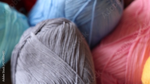 Multi colored yarn ball on a skein, background blurry