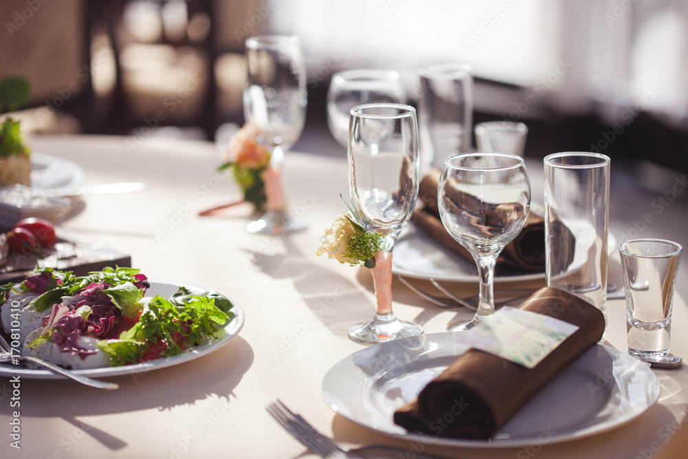 Table setting in the restaurant. floral decor on the glasses, wedding