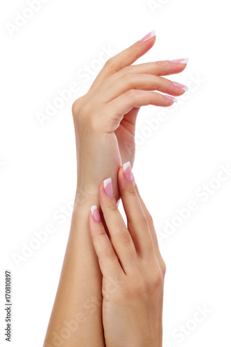 Closeup shot of woman's hands with french manicure and clean and soft skin over a white background, isolated