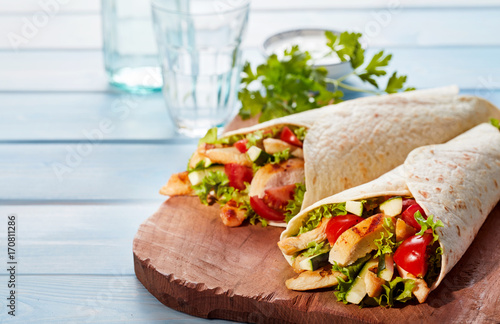 Obraz na plátně Two fresh chicken and salad tortilla wraps