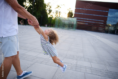 Young dad is playing with a charming little daughter. photo