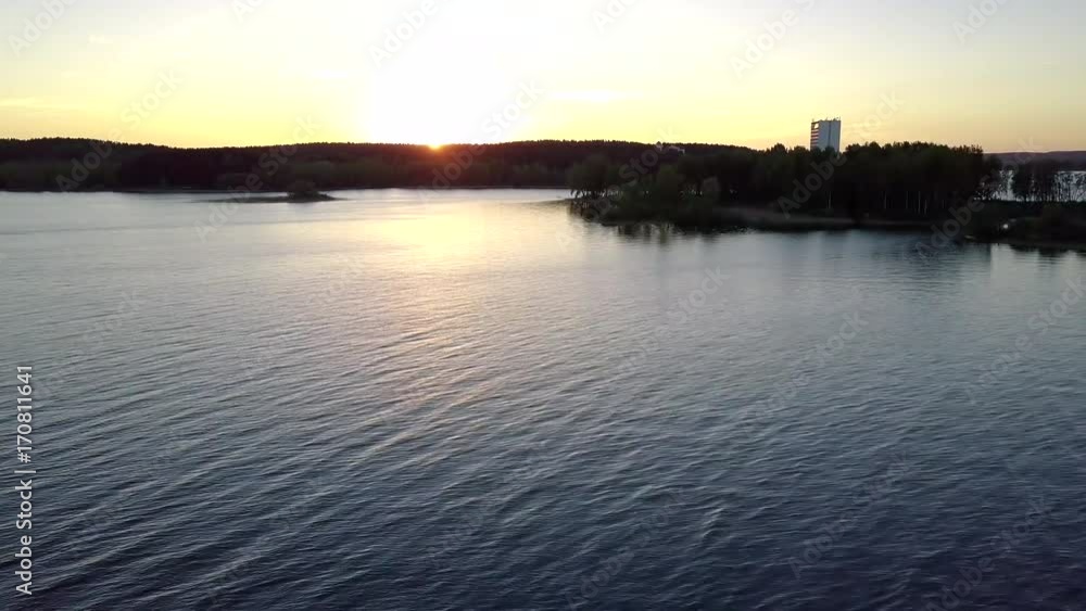 A white yacht sails on the river during a beautiful sunset. A white yacht sails on the river during a beautiful sunset.