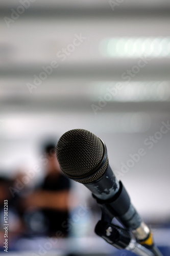 Microphone on the abstract blurred photo of seminar room background