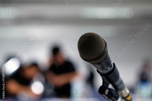 Microphone on the abstract blurred photo of seminar room background