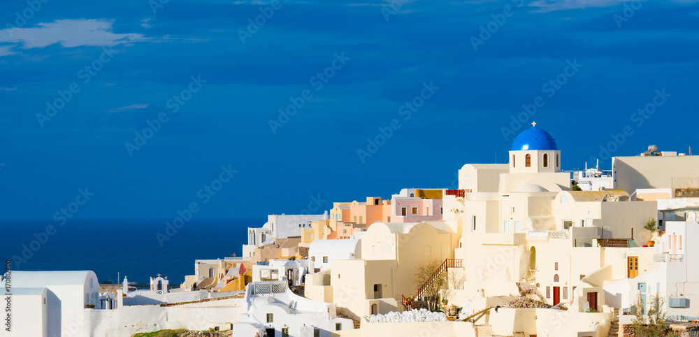 Panorama ofOia town on Santorini island, Greece. Traditional and famous white and rose  houses over the Caldera, Aegean sea