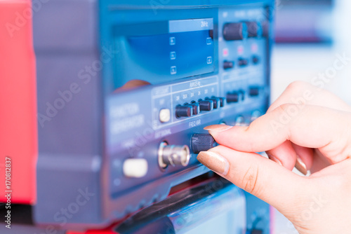 woman presses a button on an electronic measuring instrument