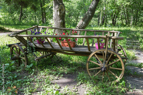 Picturesque old wooden cart with flowers