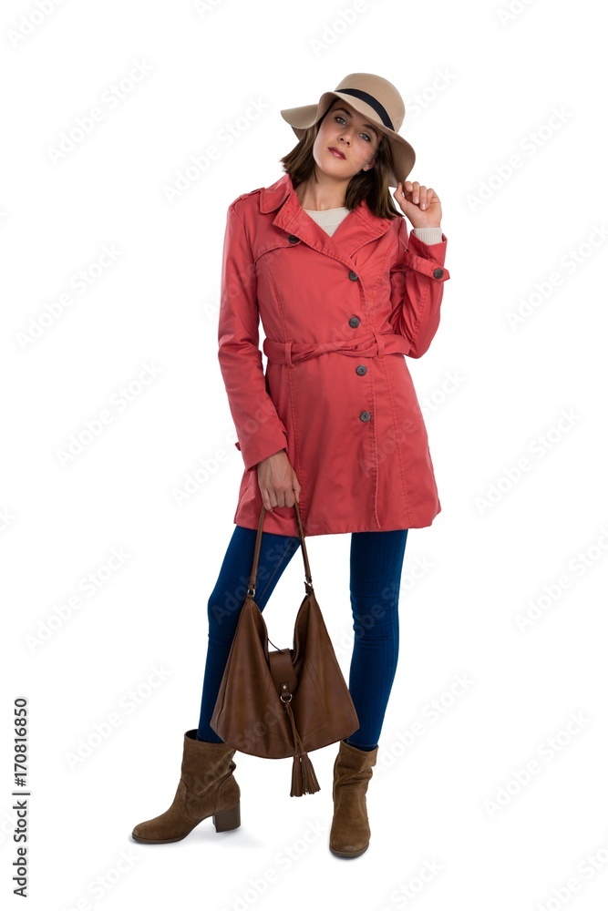 Portrait of young woman in warm clothing holding purse Portrait of young woman in warm clothing holding purse