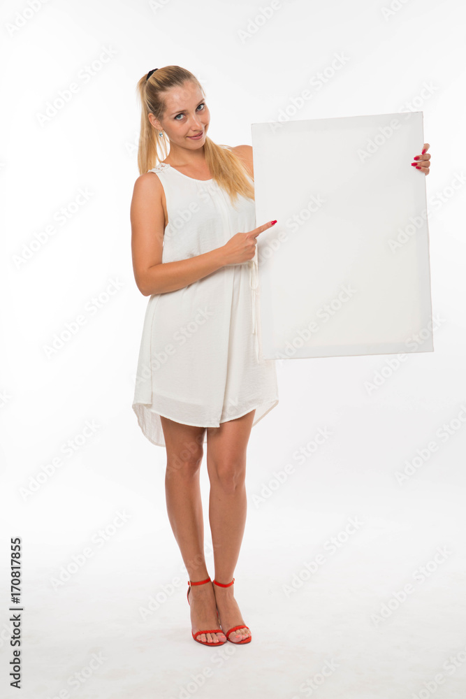 Young glad woman portrait of a confident businesswoman showing presentation, pointing placard gray background. Ideal for banners, registration forms, presentation, landings, presenting concept. Young glad woman portrait of a confident businesswoman showing presentation, pointing placard gray background. Ideal for banners, registration forms, presentation, landings, presenting concept.