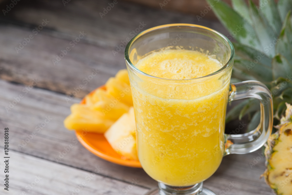 Pineapple smoothie on wood background Pineapple smoothie on wood background