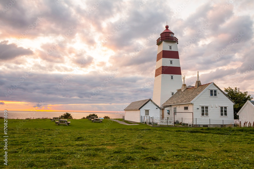 Alnes lighthouse at sunset at Godoy island near Alesund, Norway Alnes lighthouse at sunset at Godoy island near Alesund, Norway