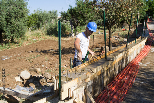 bricklayer building a new wall in a site