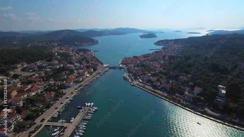 Panoramic aerial view to the neighborhood of a picturesque Croatian town, divided by a strait and connected by a bridge. 2K7 video. Panoramic aerial view to the neighborhood of a picturesque Croatian town, divided by a strait and connected by a bridge. 2K7 video.