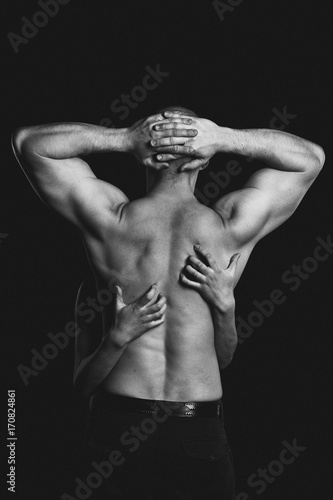 bodybuilder in the women's arms on black background