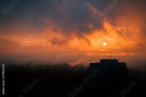 Smoke from plants in the city at sunset