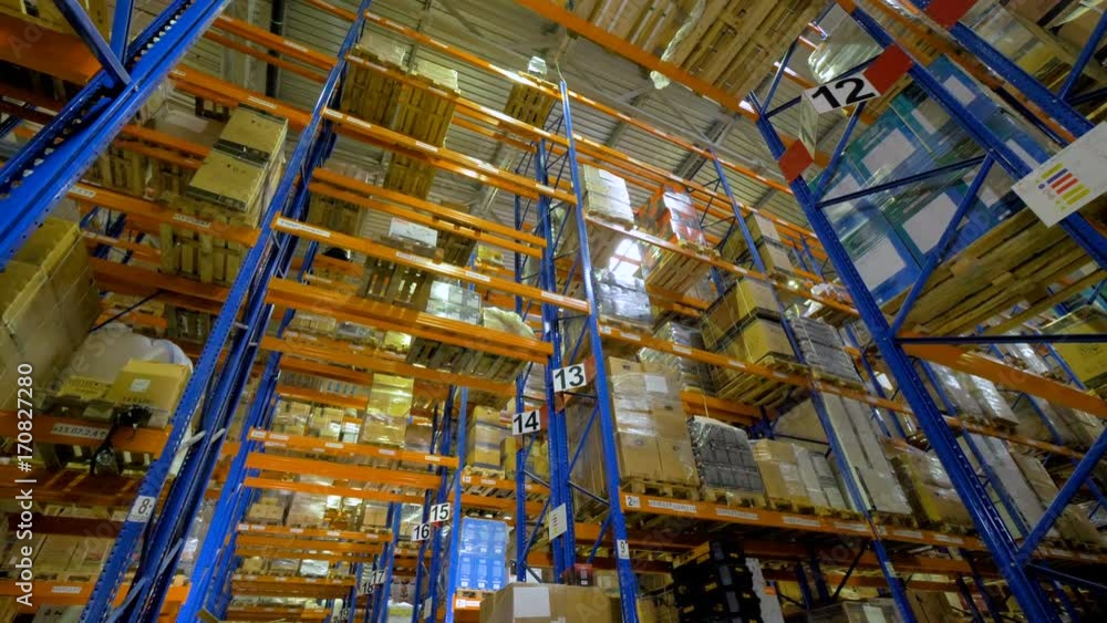 Huge warehouse. Cardboard boxes on shelves inside a storage warehouse. 4K. Huge warehouse. Cardboard boxes on shelves inside a storage warehouse. 4K.