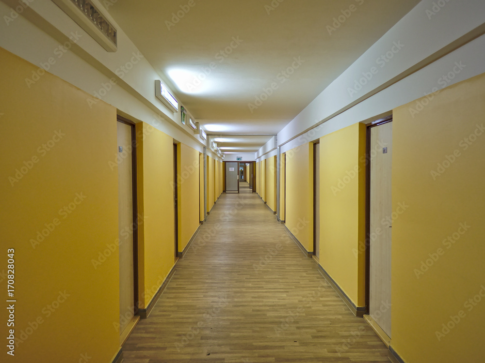 Long empty dormitory corridor with vintage style.