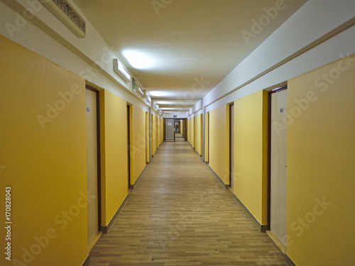 Fototapeta Long empty dormitory corridor with vintage style.