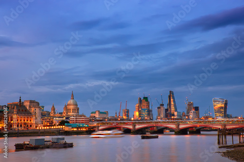 Illuminated London, view over Thames river at night