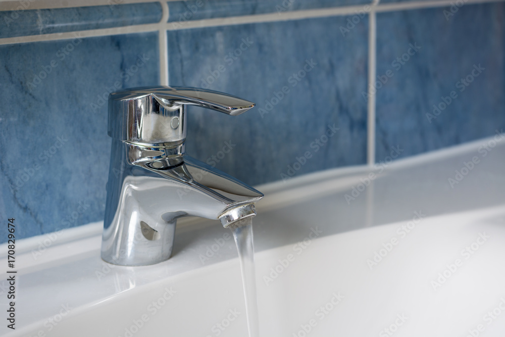 Water flowing from water tap in the bathroom Water flowing from water tap in the bathroom