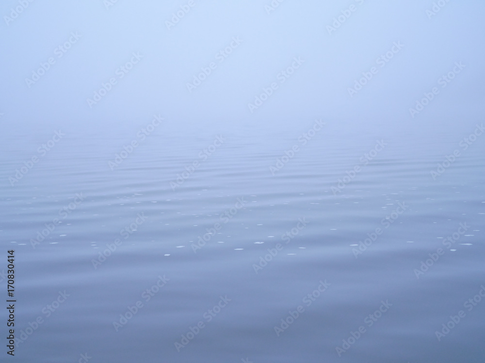 Peaceful surface of sea covered by thick white mist. Peaceful surface of sea covered by thick white mist.