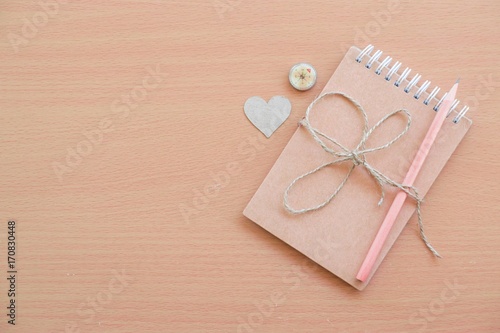  Notepad with pencil on wood board background.using wallpaper for education, business photo.Take note of the product for book with paper and concept or copy space and advertising.