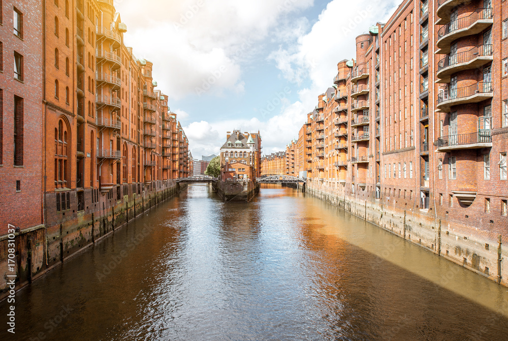 Beautiful view on the water channel with old red warehouses in Hafen district of Hamburg city, Germany