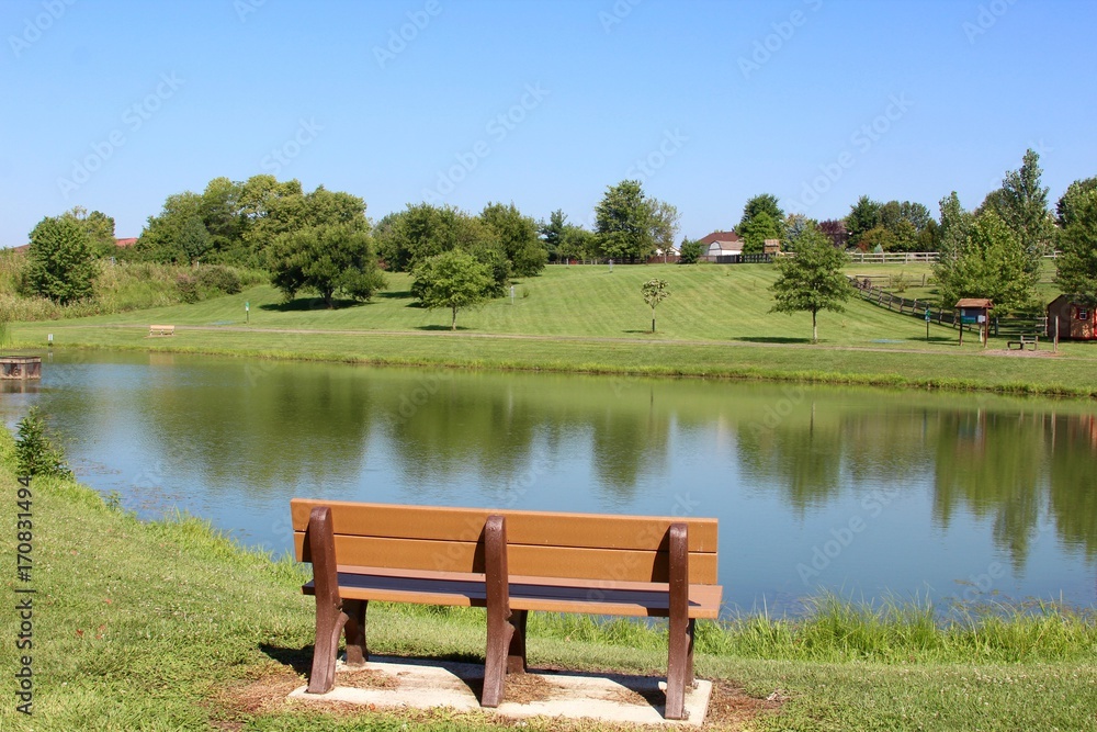 The empty wood bench at the lake.