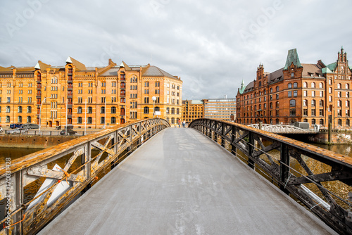 View on the old iron bridge and red brick warehouses in Hafen district of Hamburg city in Germany