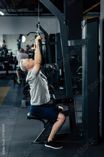 senior sportsman lifting weights
