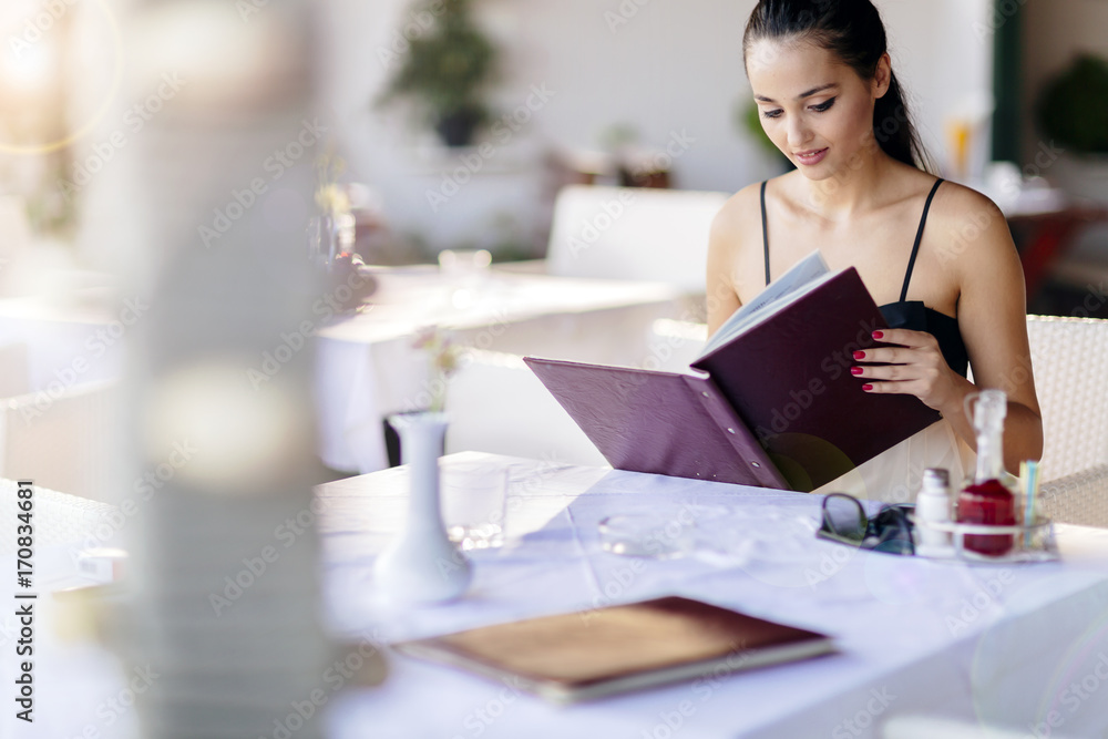 Beautiful woman ordering from menu Beautiful woman ordering from menu