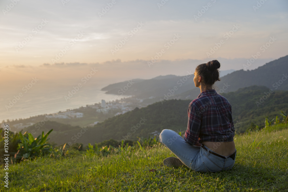 Hipster young girl enjoying sunset on peak mountain. Tourist traveler on background valley landscape view mockup.