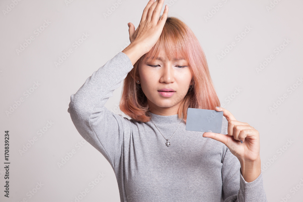 Young Asian woman headache with a blank card. Young Asian woman headache with a blank card.